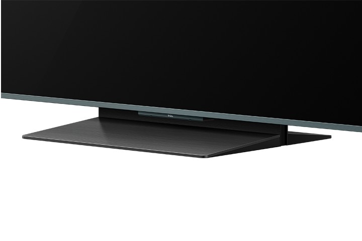 The TV is equipped with a compact, height-adjustable central stand. In its lowest position, the stand raises the TV approximately 6 cm above the table, and in its highest position, 10 cm, which is sufficient for almost any soundbar.